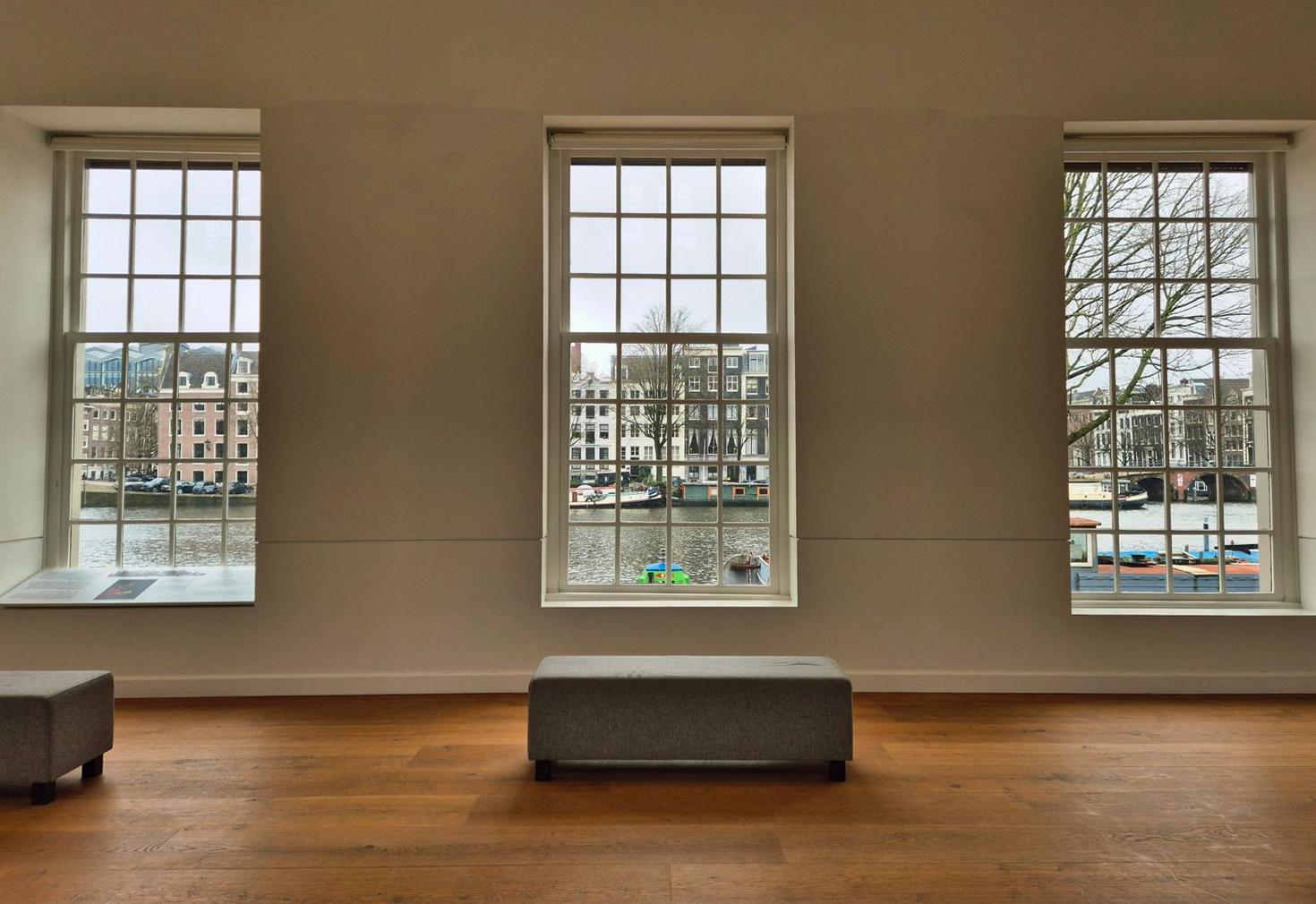 Minimalist Amsterdam hotel interior with tranquil canal view